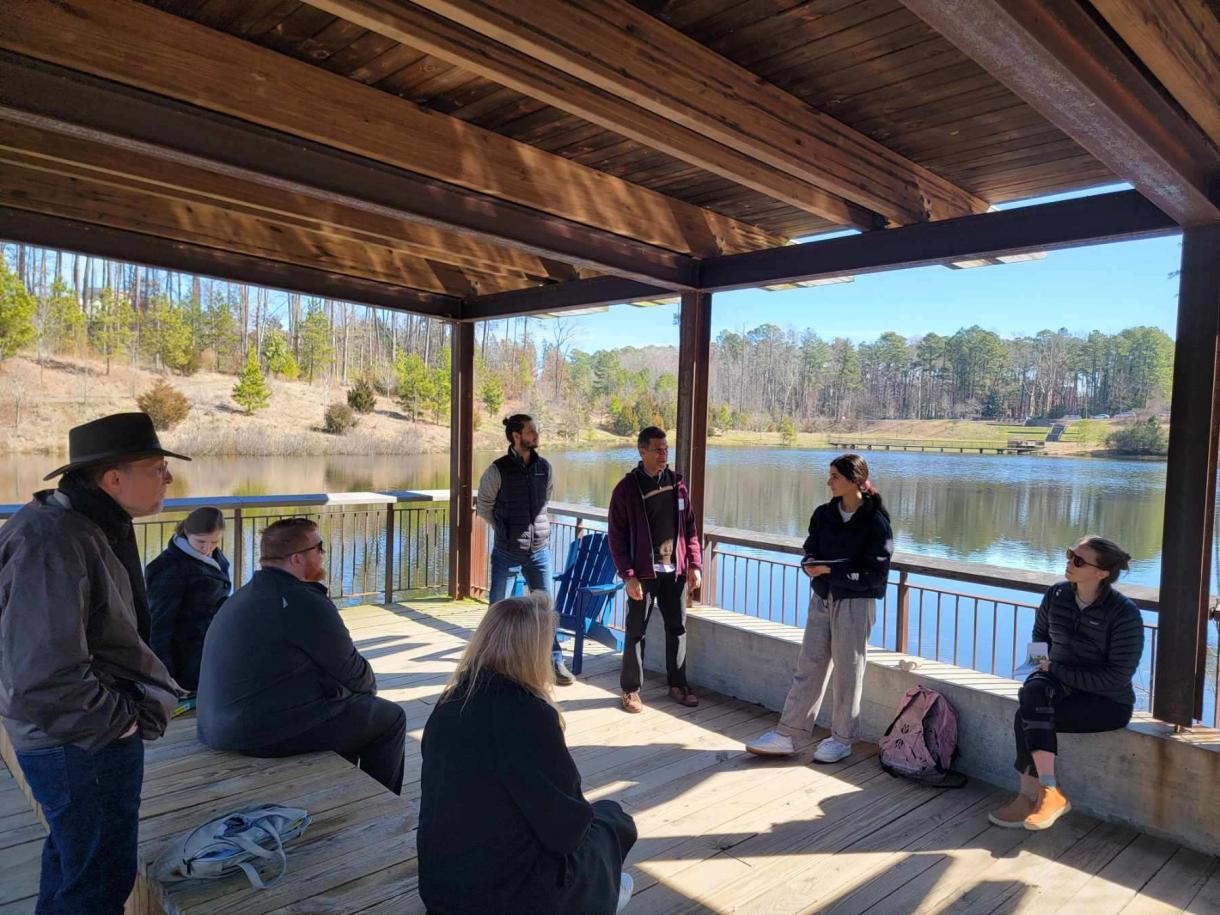 photo of Dr. Brian McAdoo talking with visitors about geothermal at the Duke Pond